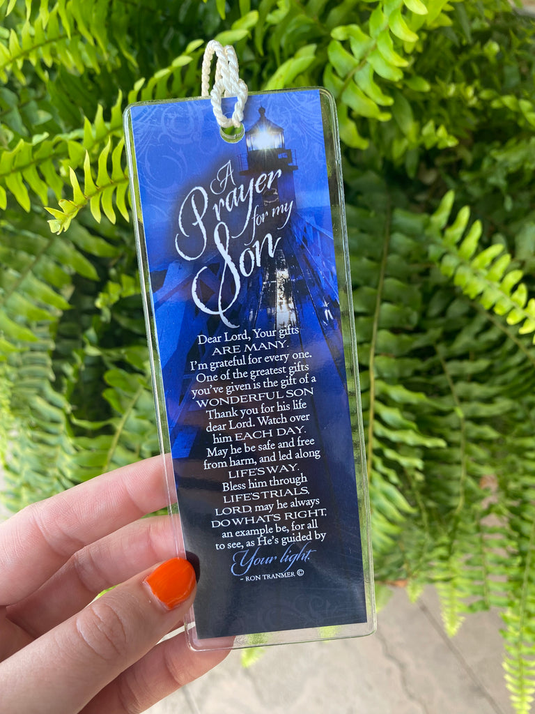 A Prayer for my son A prayer for my mom Double sided, plastic cover spiritual bookmark being held up in front of a green fern