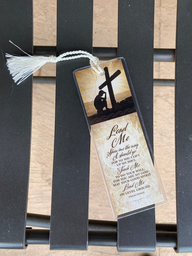 lead me bookmark on a black metal bench