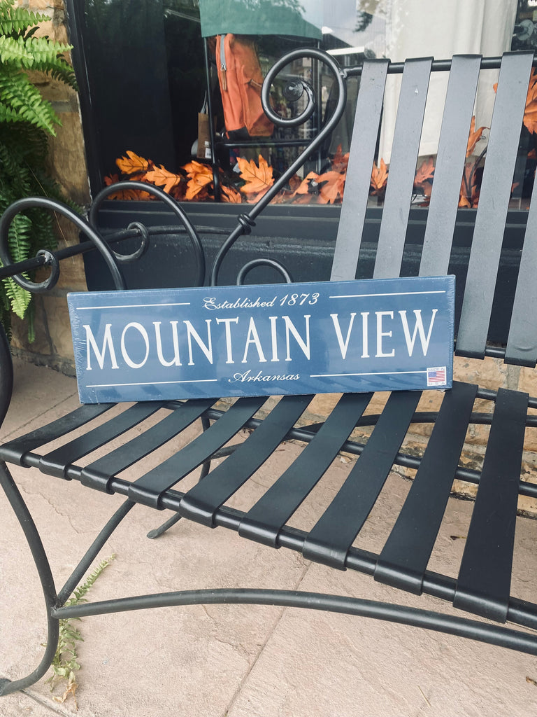 mountain view established wooden plaque on a black metal bench