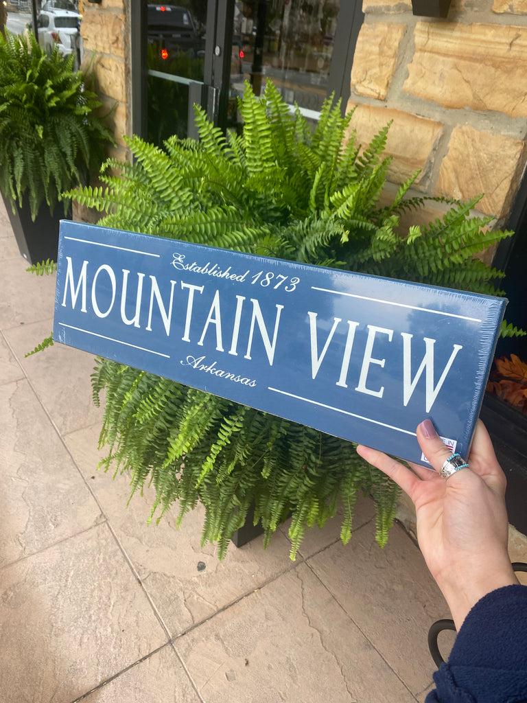 mountain view established wooden plaque on a black metal bench