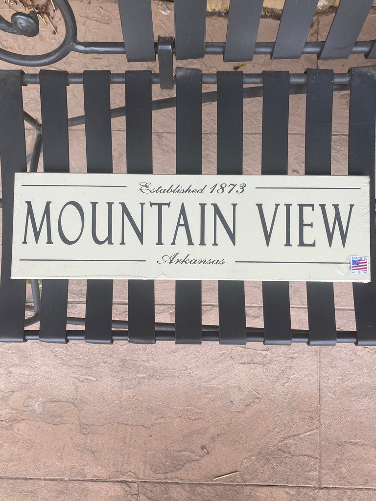 mountain view established wooden plaque on a black metal bench