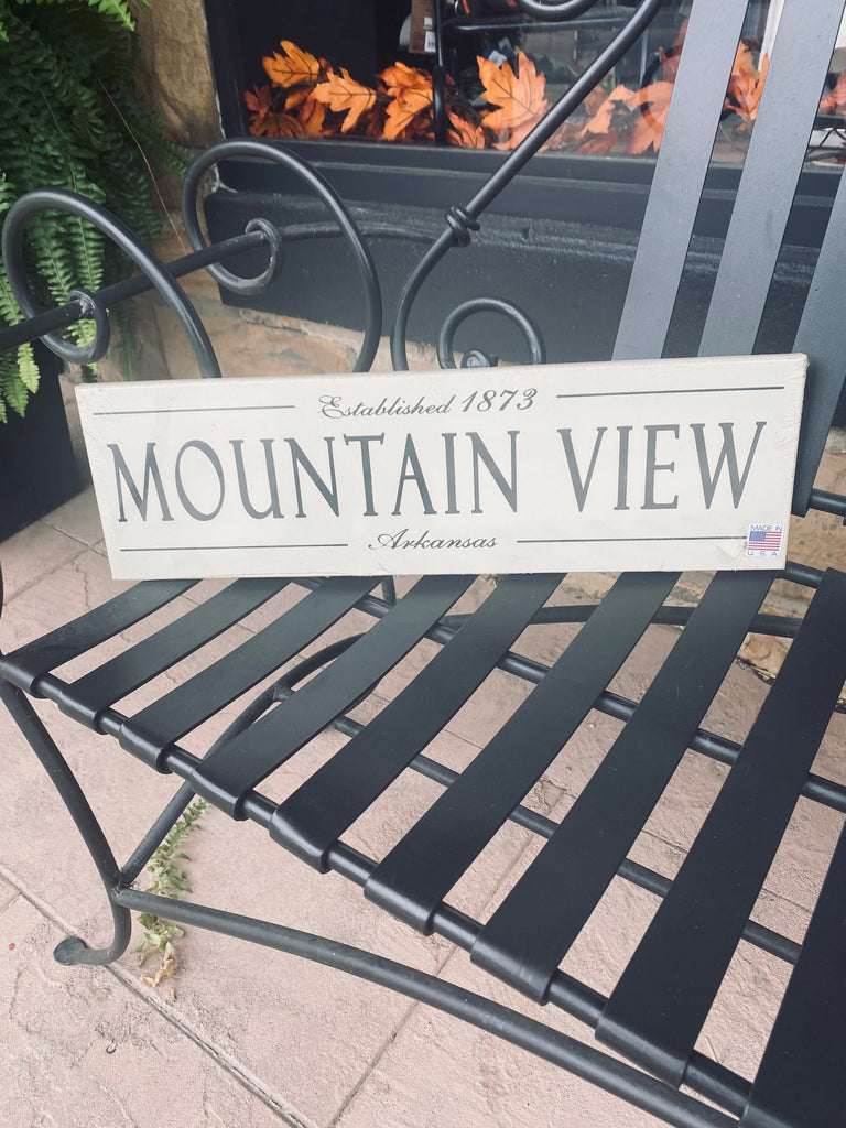 mountain view established wooden plaque on a black metal bench