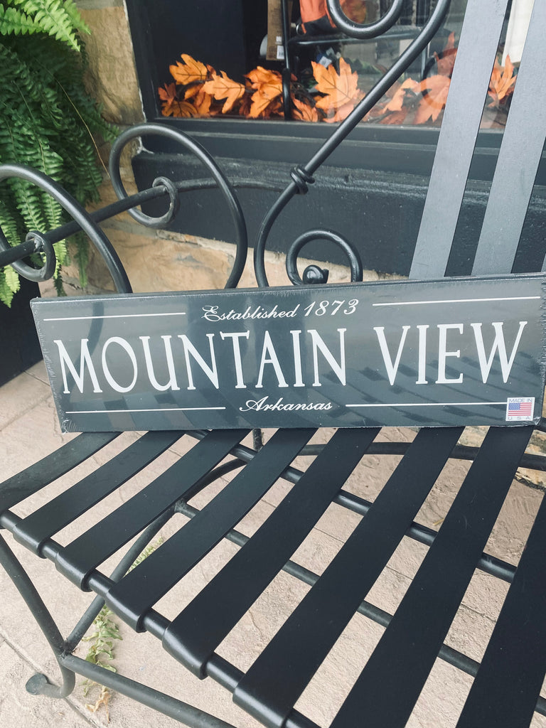 mountain view established wooden plaque on a black metal bench