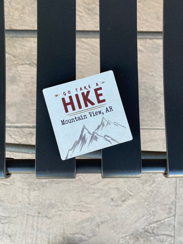 take a hike Mountain View Arkansas magnet on a black metal bench