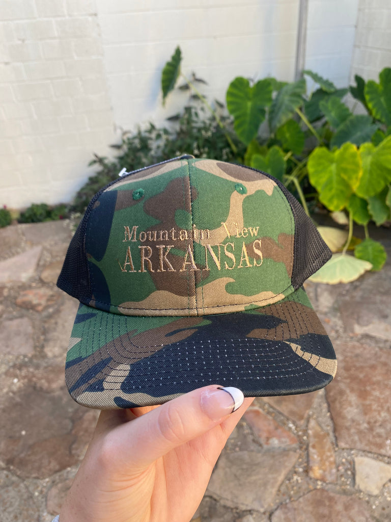 mountain view arkansas hat in front of a rock floor