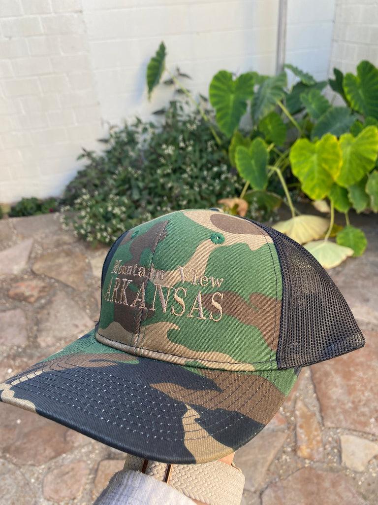 mountain view arkansas hat in front of a rock floor