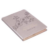 Decorative notebook with floral design and text on a white background