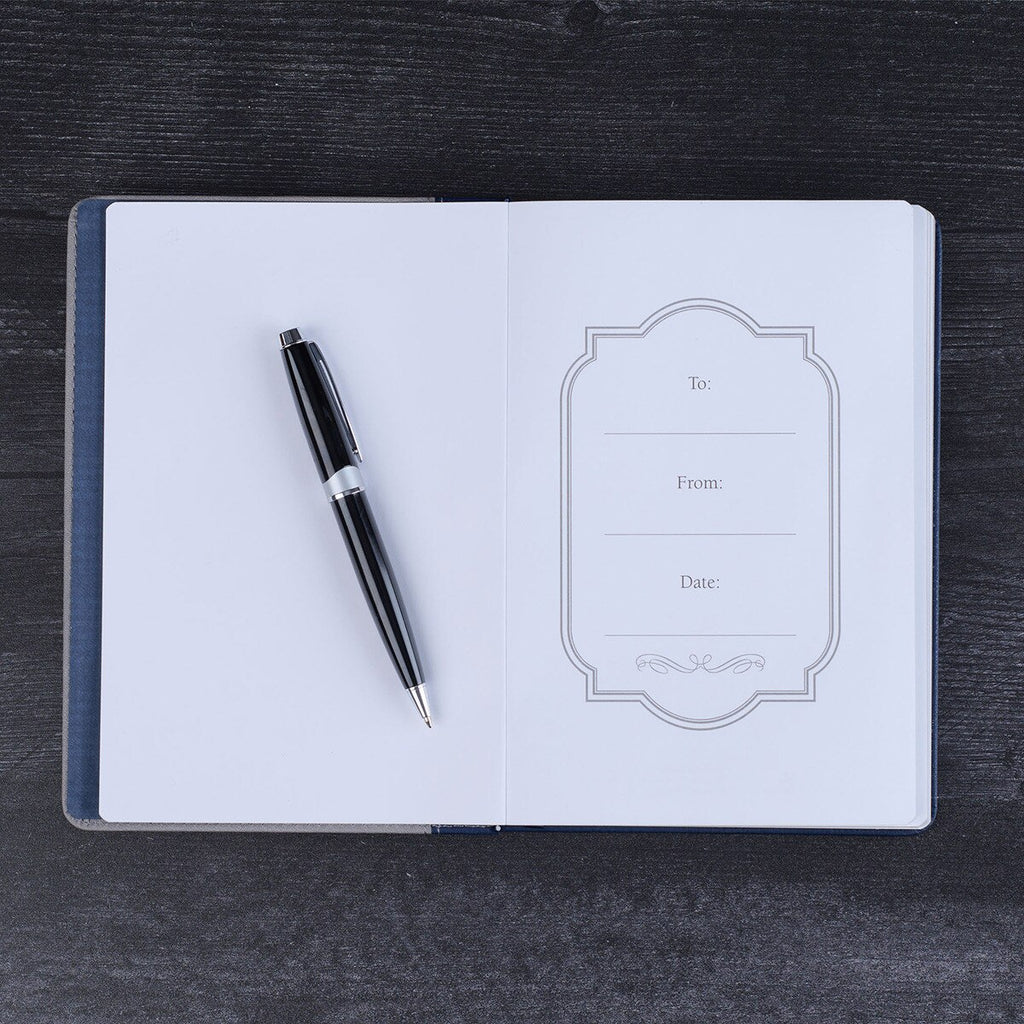 Open notebook with a pen on a dark wooden surface