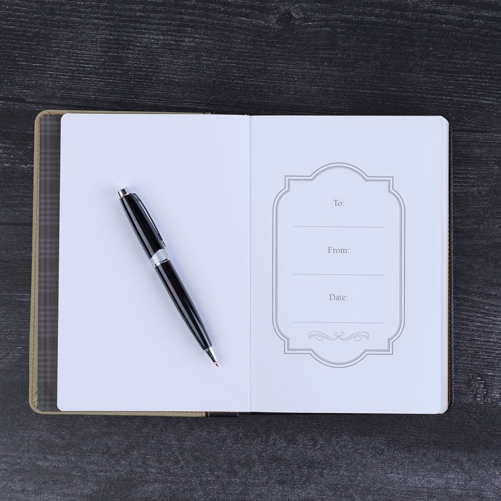 Open notebook with a pen on a dark wooden surface