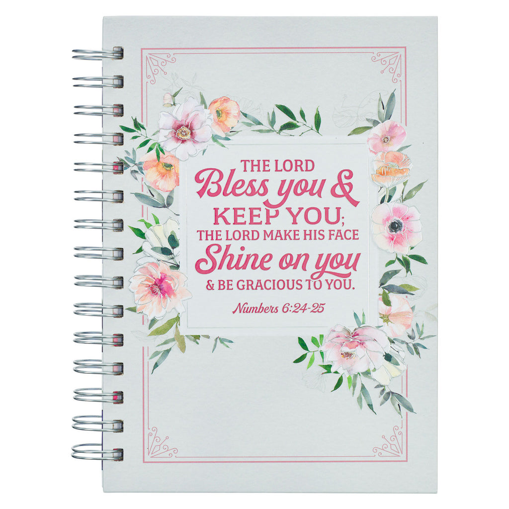white and pink floral journal on a white background