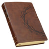 Brown leather-bound book with embossed design on a white background