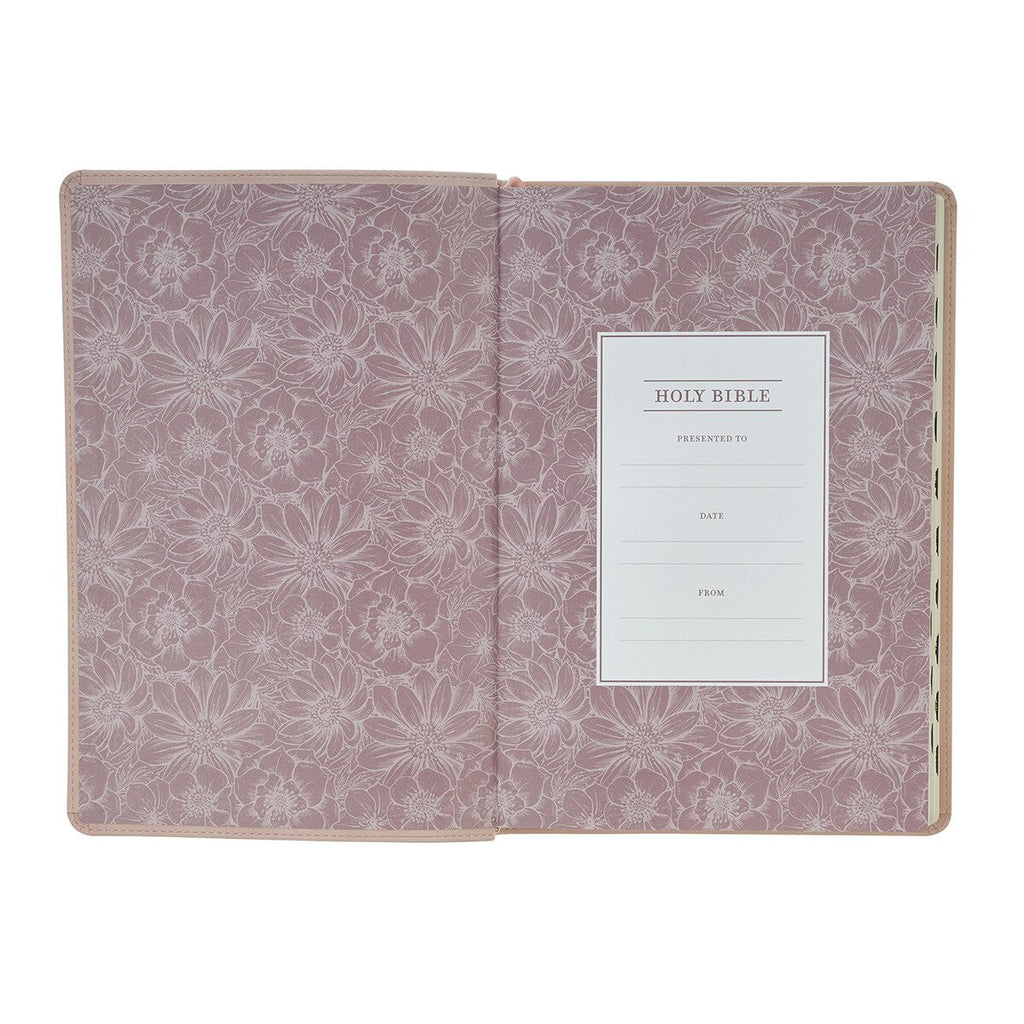 Floral-patterned cover of a Holy Bible with a white label on a white background