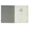 Open Bible with a gray cover and white interior on a white background