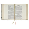 Open Bible with floral design on the cover on a white background