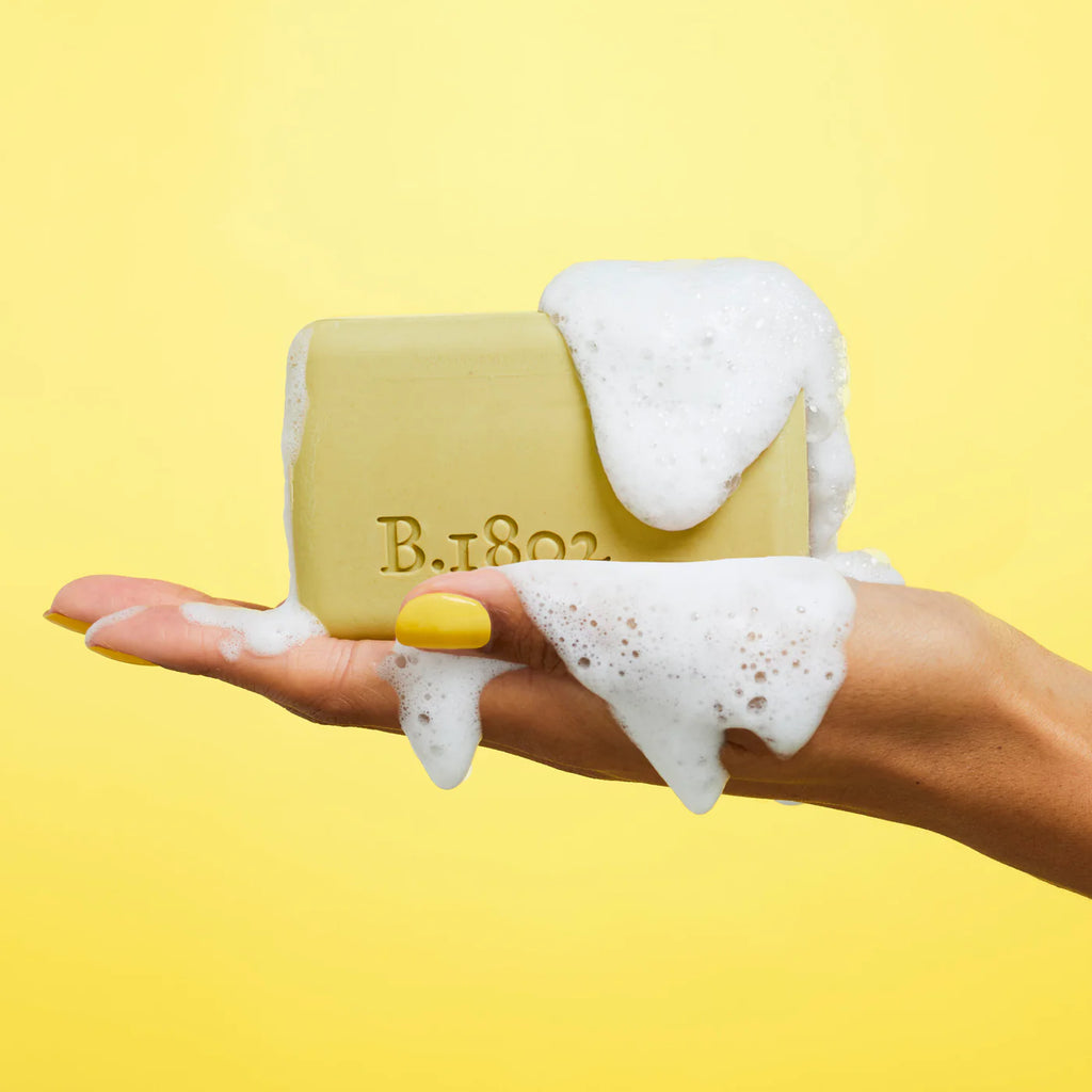 beekman golden bar soap on a yellow background