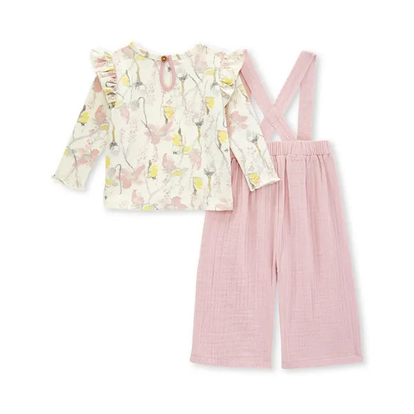 burts bee baby pink overall and floral ruffle shoulder long sleeve shirt on a white background