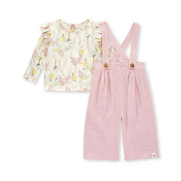 burts bee baby pink overall and floral ruffle shoulder long sleeve shirt on a white background 