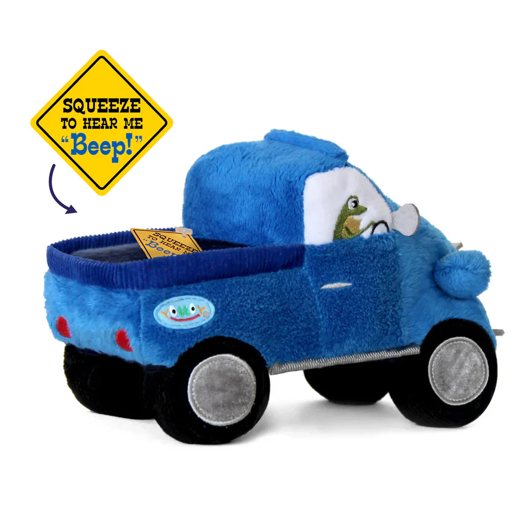 Blue plush toy truck with a frog driver and 'Squeeze to Hear Me Beep!' sign.