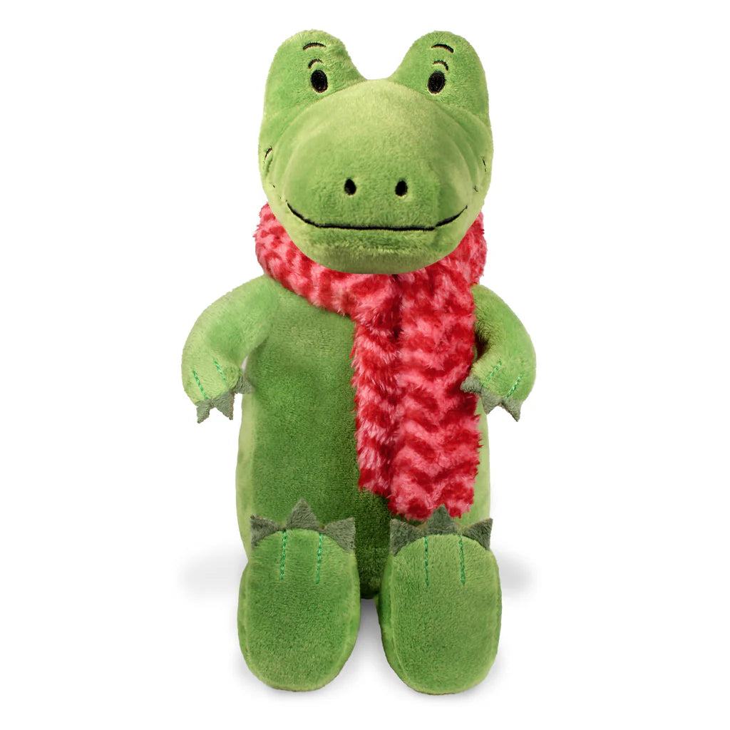 Green plush toy with a red scarf on a white background