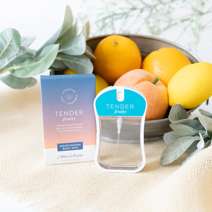 Tender fruity body mist packaging with a bowl of fruits on a light surface