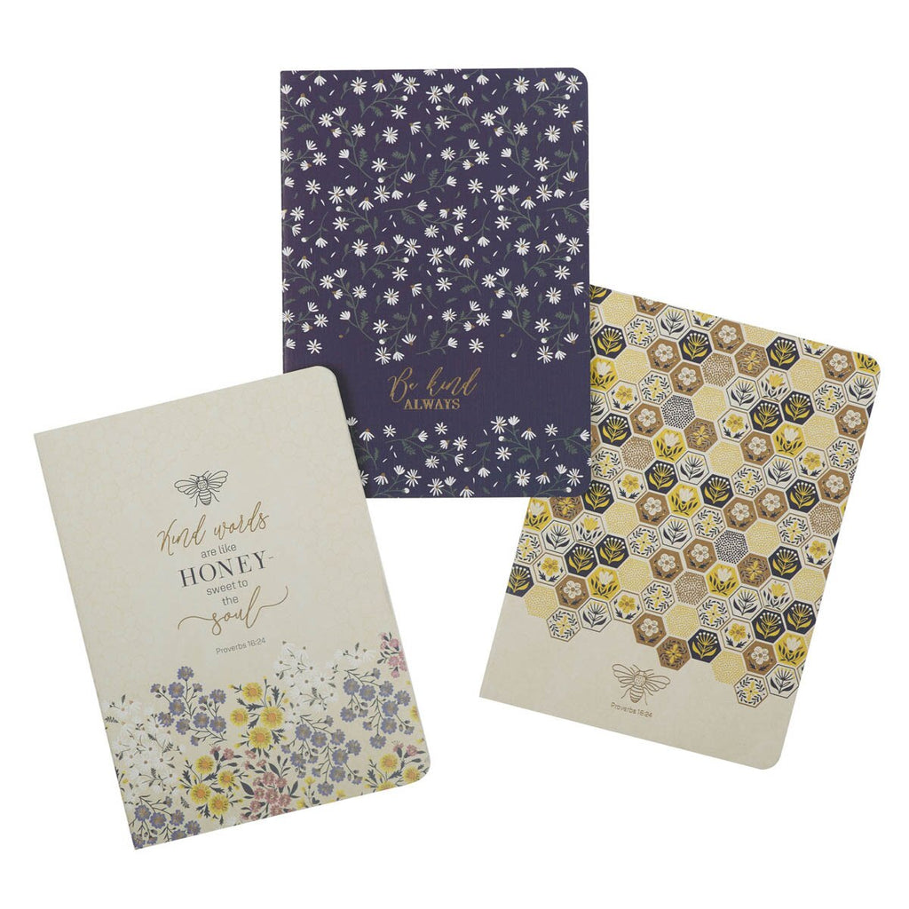 Three notebooks with floral and honeycomb designs on a white background