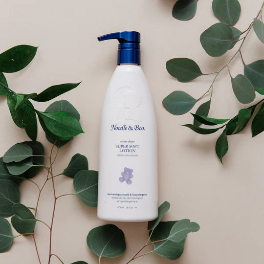 noodle and boo lotion on a cream background with leaves