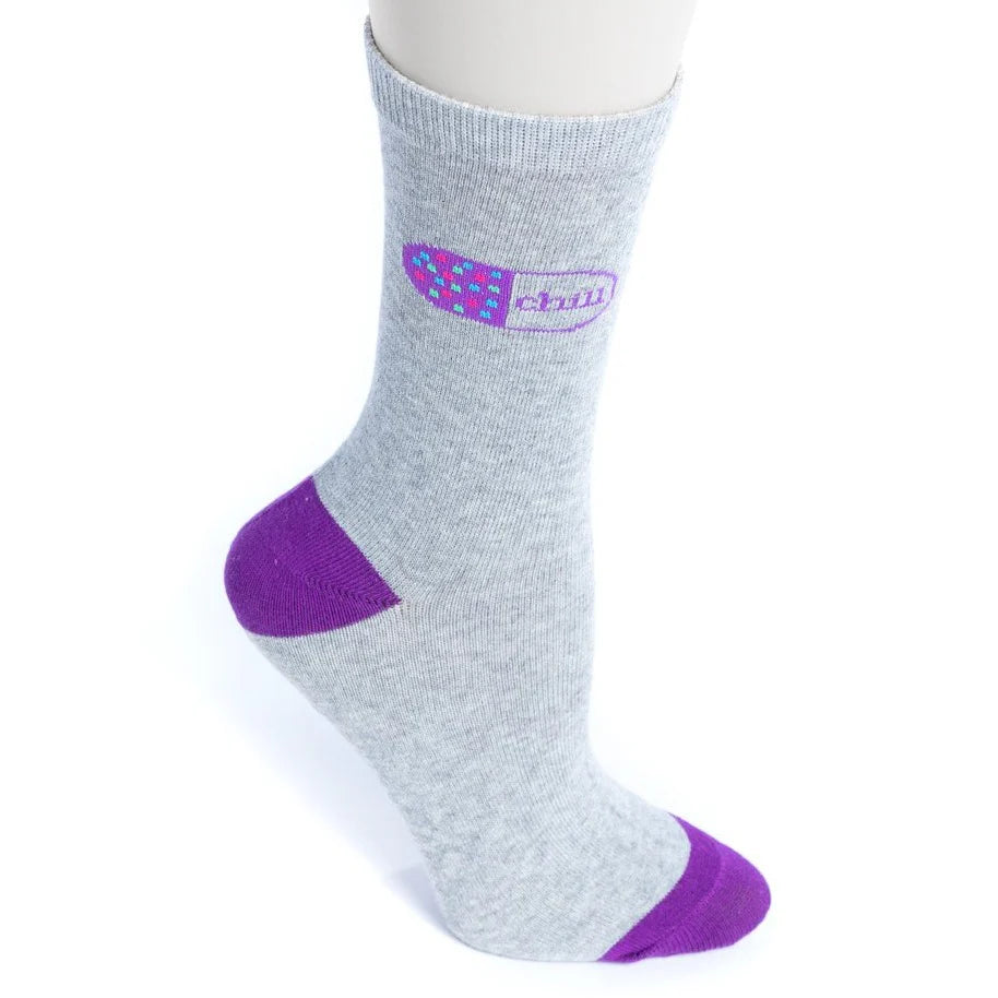 nurseology chill pill socks on a white background