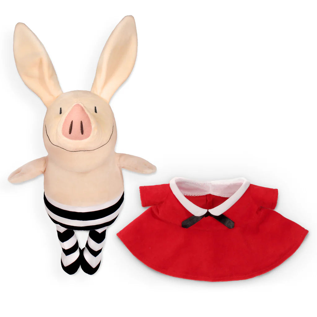 Plush toy piglet with a red dress on a white background