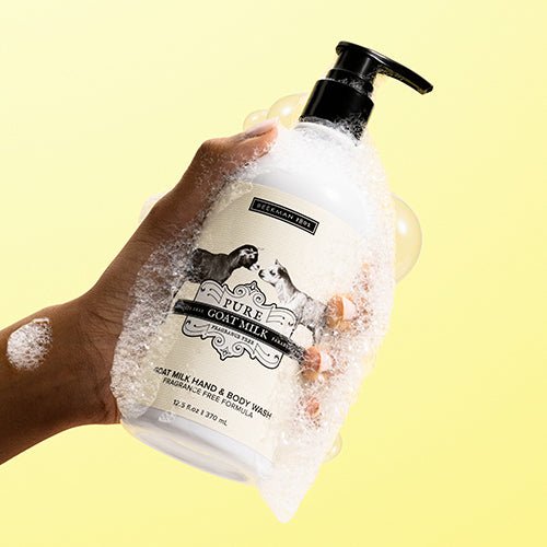 pure goat milk hand and body wash on a yellow background