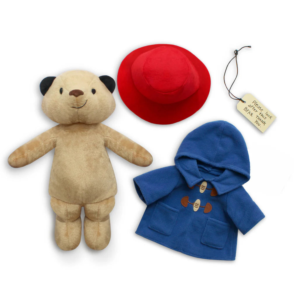 Teddy bear with red hat and blue coat on a white background