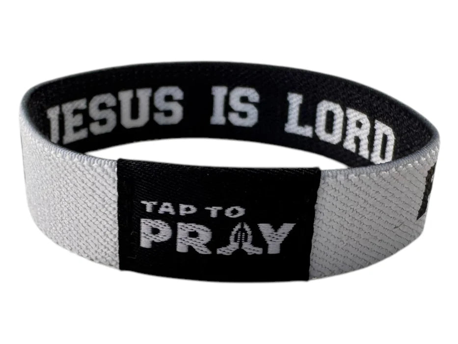 Black and gray wristband with 'Jesus is Lord' and 'Tap to Pray' text on a white background