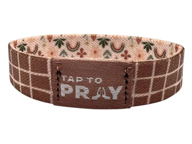 Brown woven bracelet with 'Tap to Pray' text on a white background