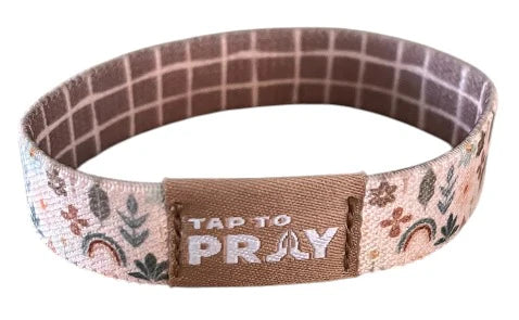 Bracelet with floral design and 'Tap to Pray' text on a white background