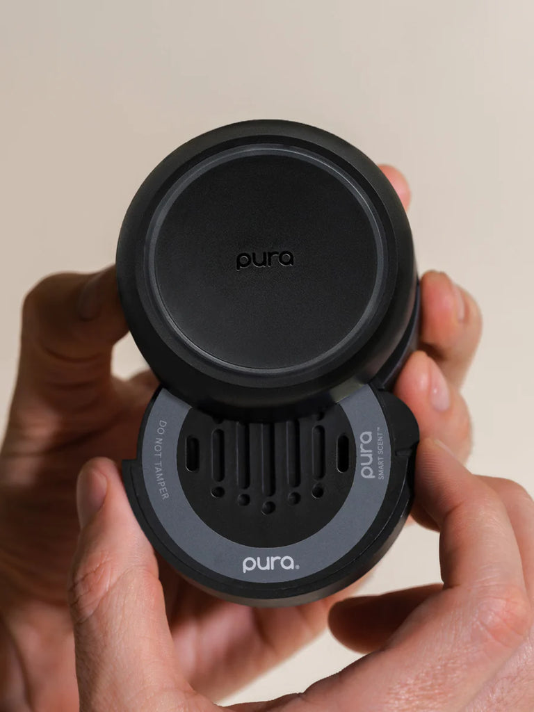Pura water bottle cap held by a person against a neutral background