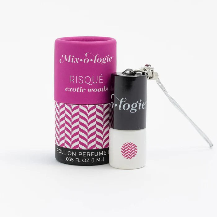 Roll-on perfume with pink packaging and black cap on a white background