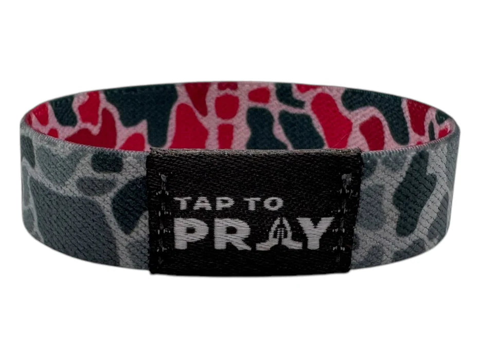 Wristband with camouflage pattern and 'Tap to Pray' label on a white background