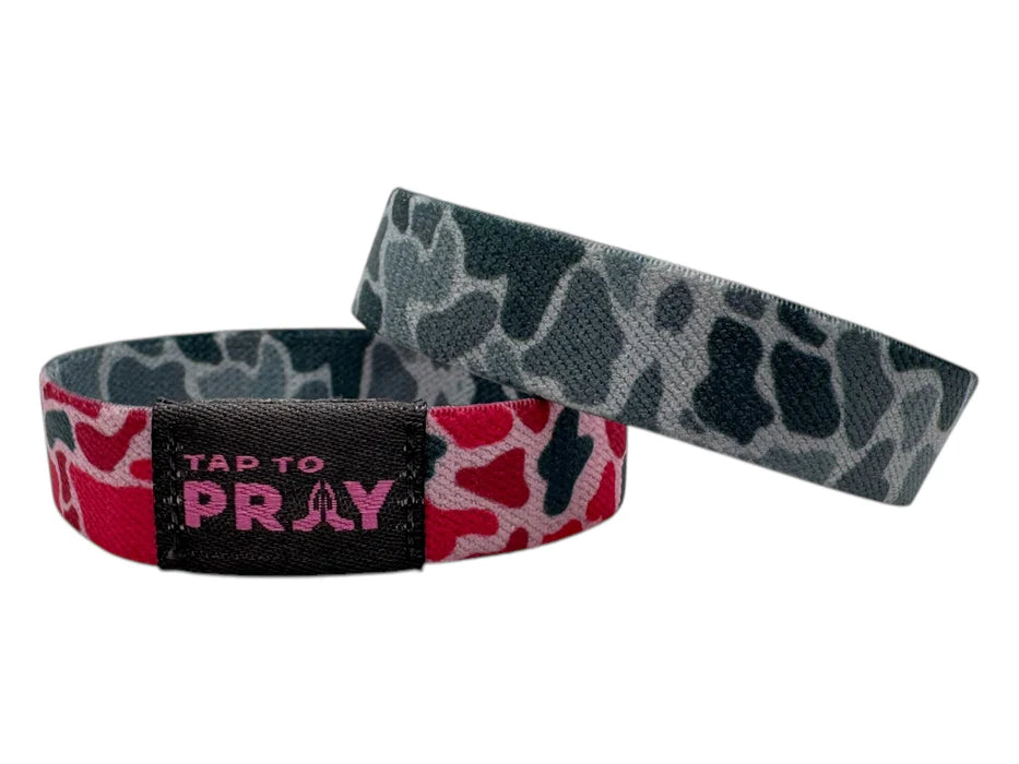 Two wristbands with camouflage and pink designs on a white background