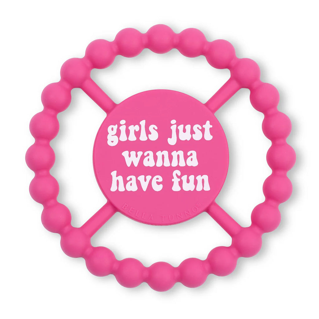 Pink teething ring with 'girls just wanna have fun' text on a white background