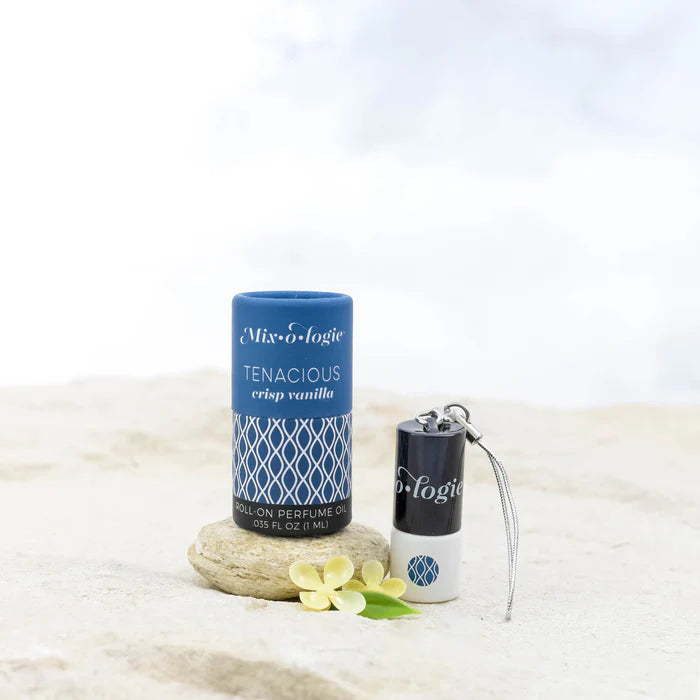 Roll-on perfume bottle with packaging on a light background