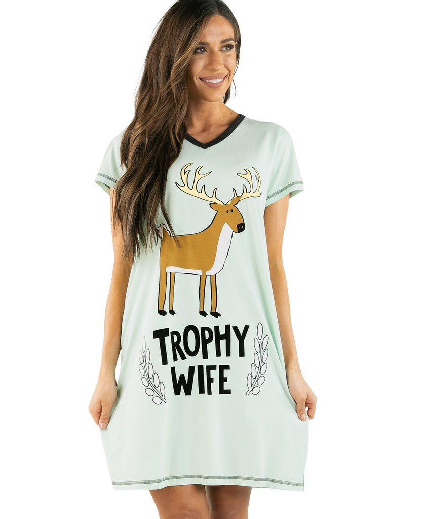 Woman wearing a light green t-shirt dress with a deer graphic and 'Trophy Wife' text on a white background