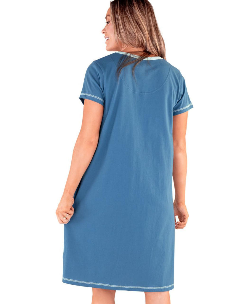 Woman wearing a blue nightshirt on a white background