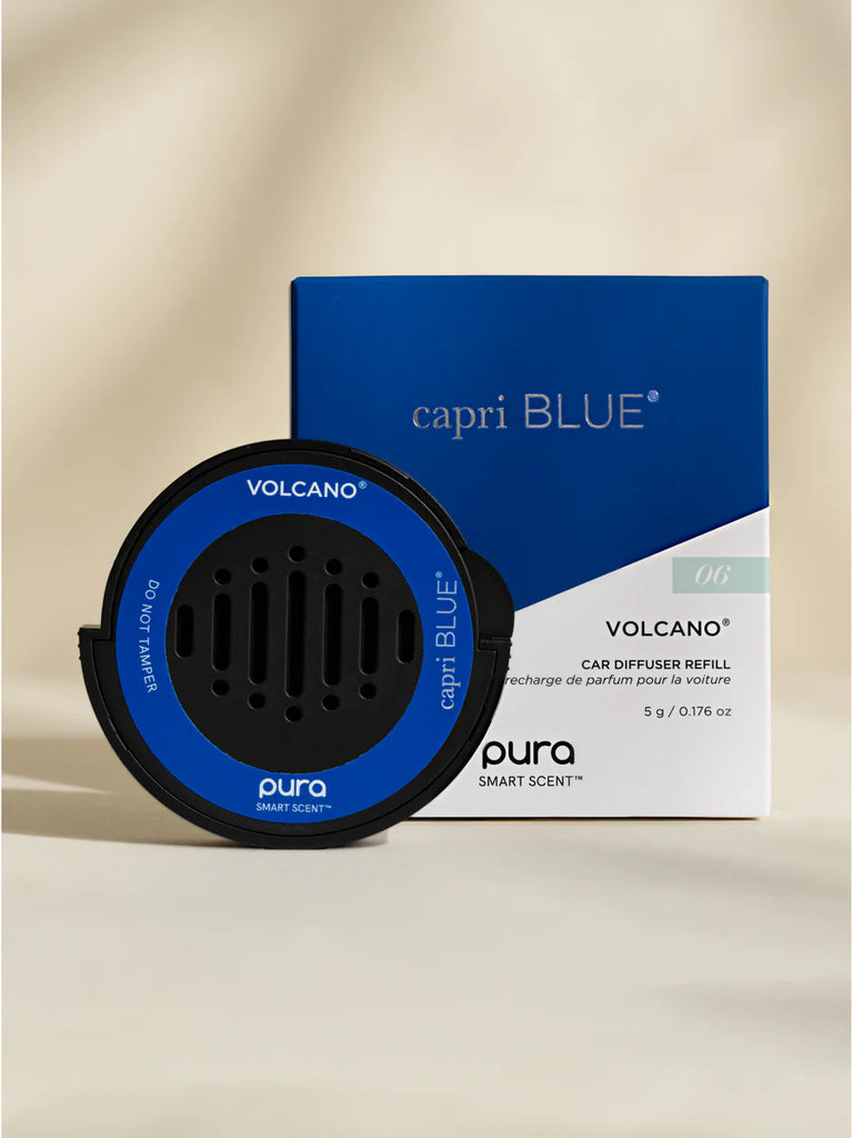 Pura Volcano car diffuser refill and capri BLUE packaging on a beige background