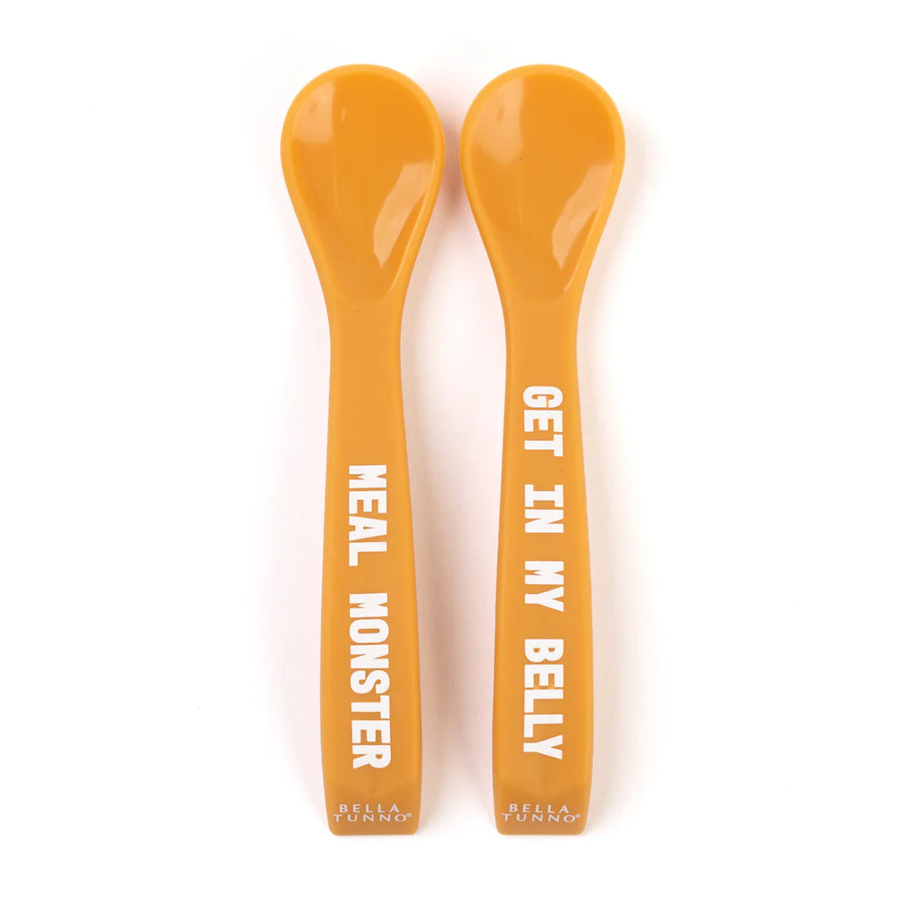 Two orange spoons with text on a white background