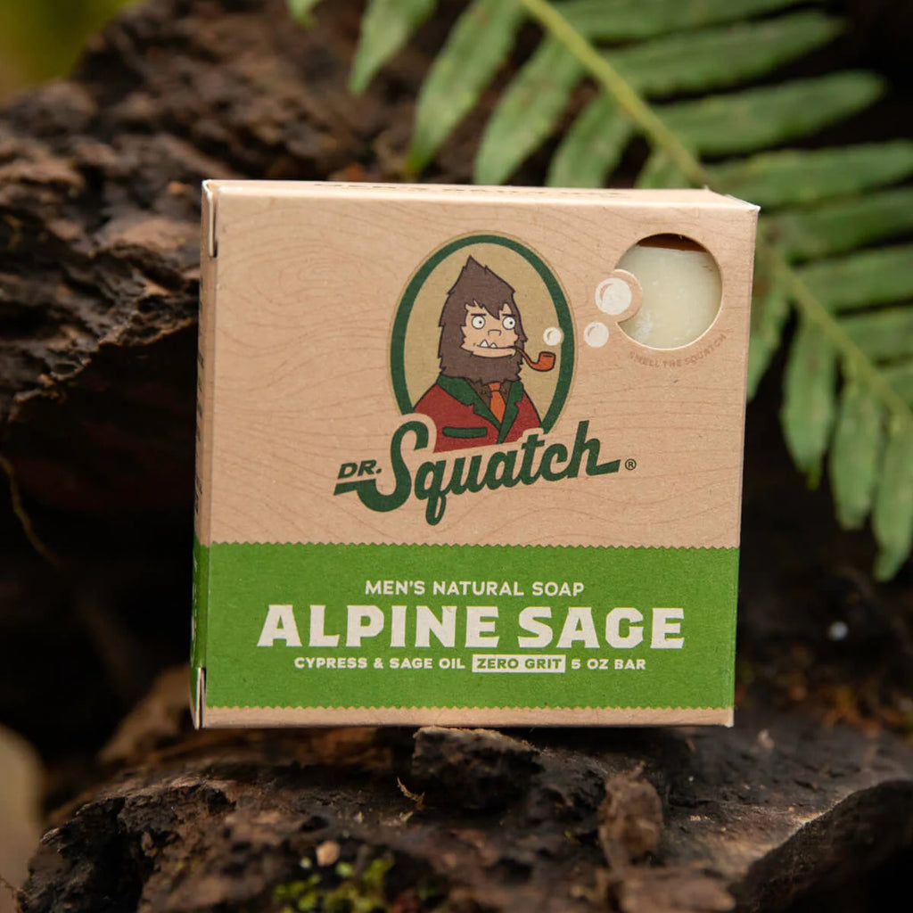 dr squatch alpine sage soap on a rock in the forrest