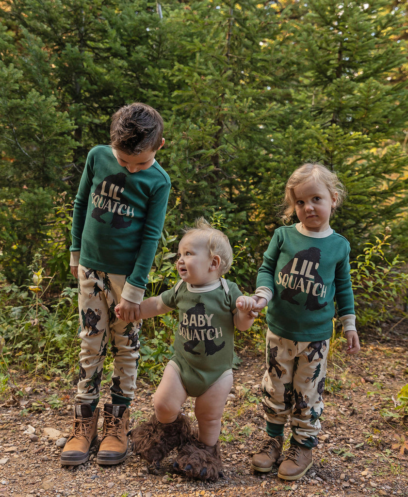 children in woods wear lazy one squatch pajamas 