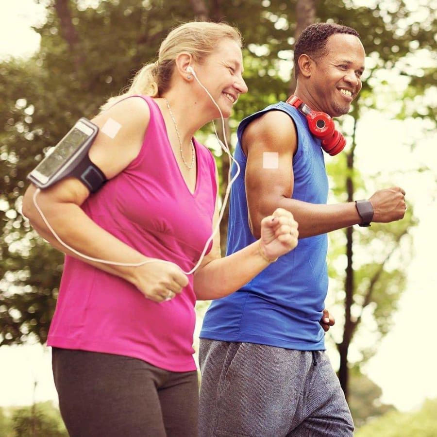 people running in front of trees wearing patches