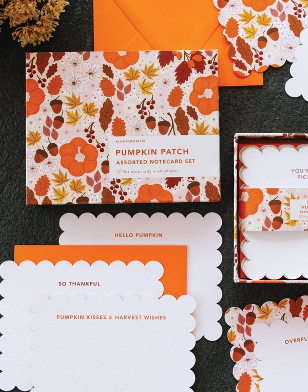 Assorted notecards with autumnal design on a dark surface