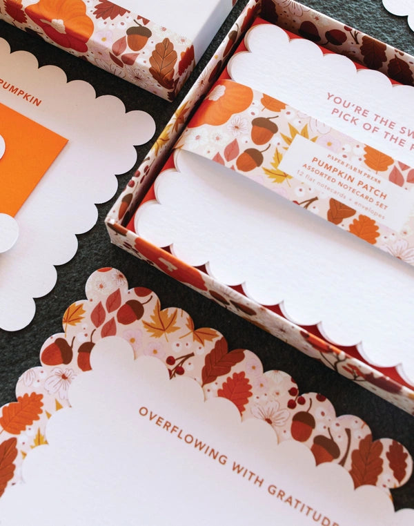 Pumpkin-themed product packaging with decorative elements on a black surface