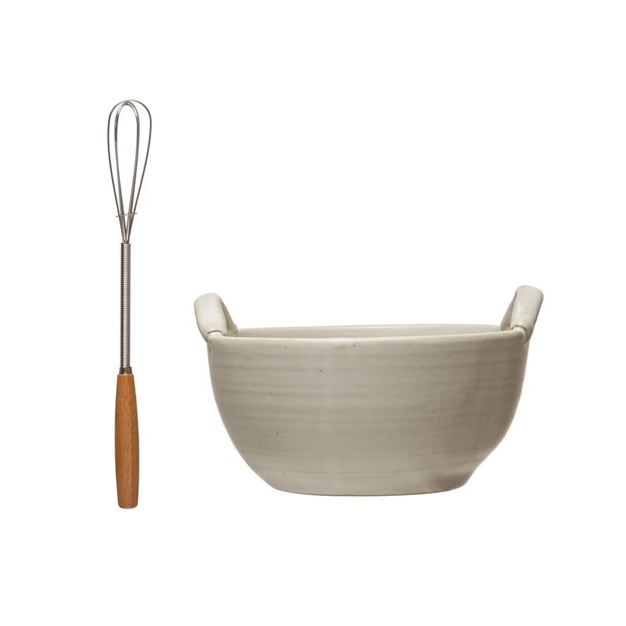 stoneware batter bowl and metal whisk on a white background