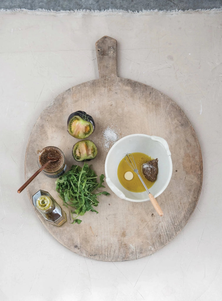 stoneware batter bowl and metal whisk on a white background